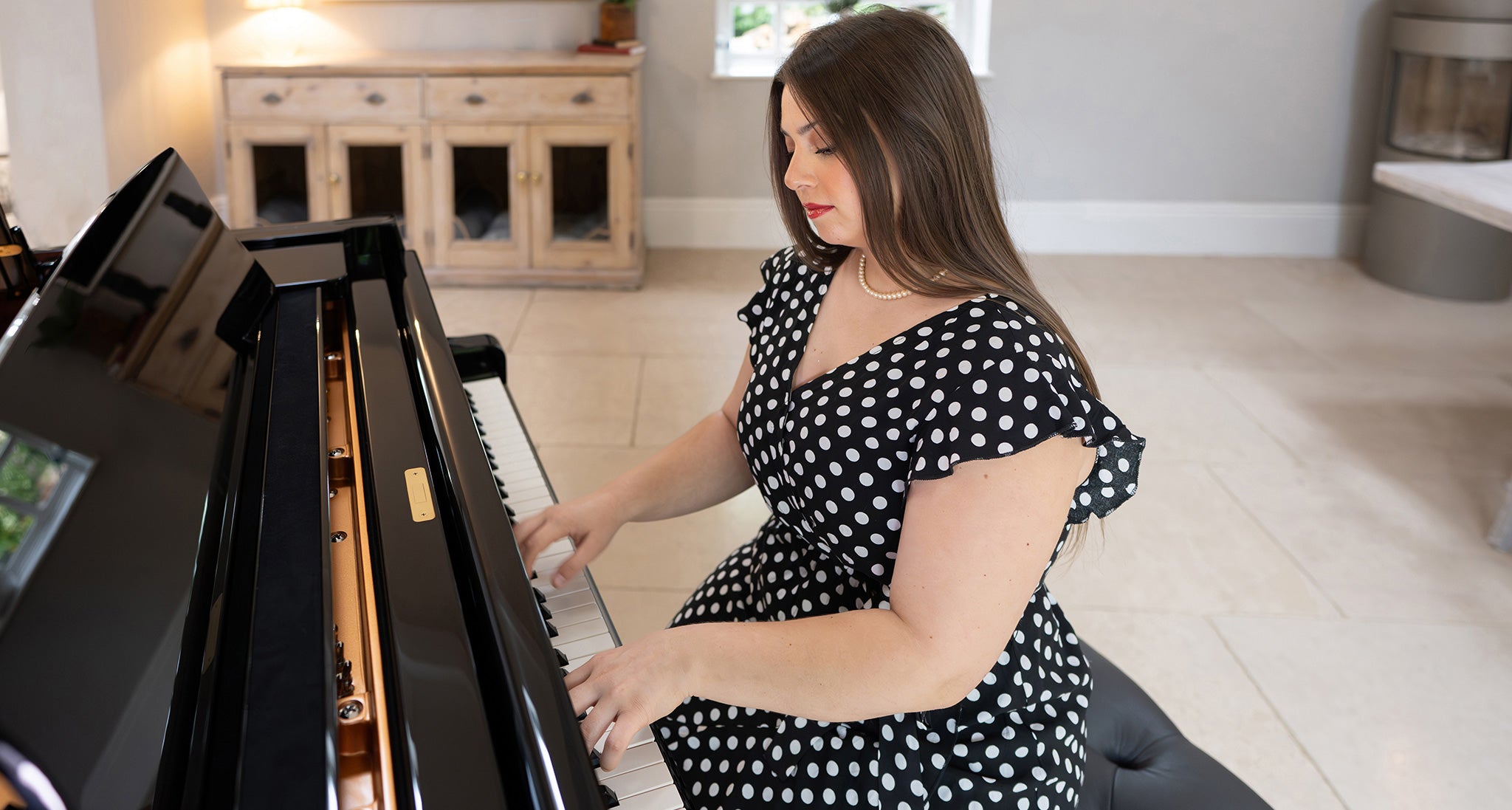 Woman playing a Kawai grand piano