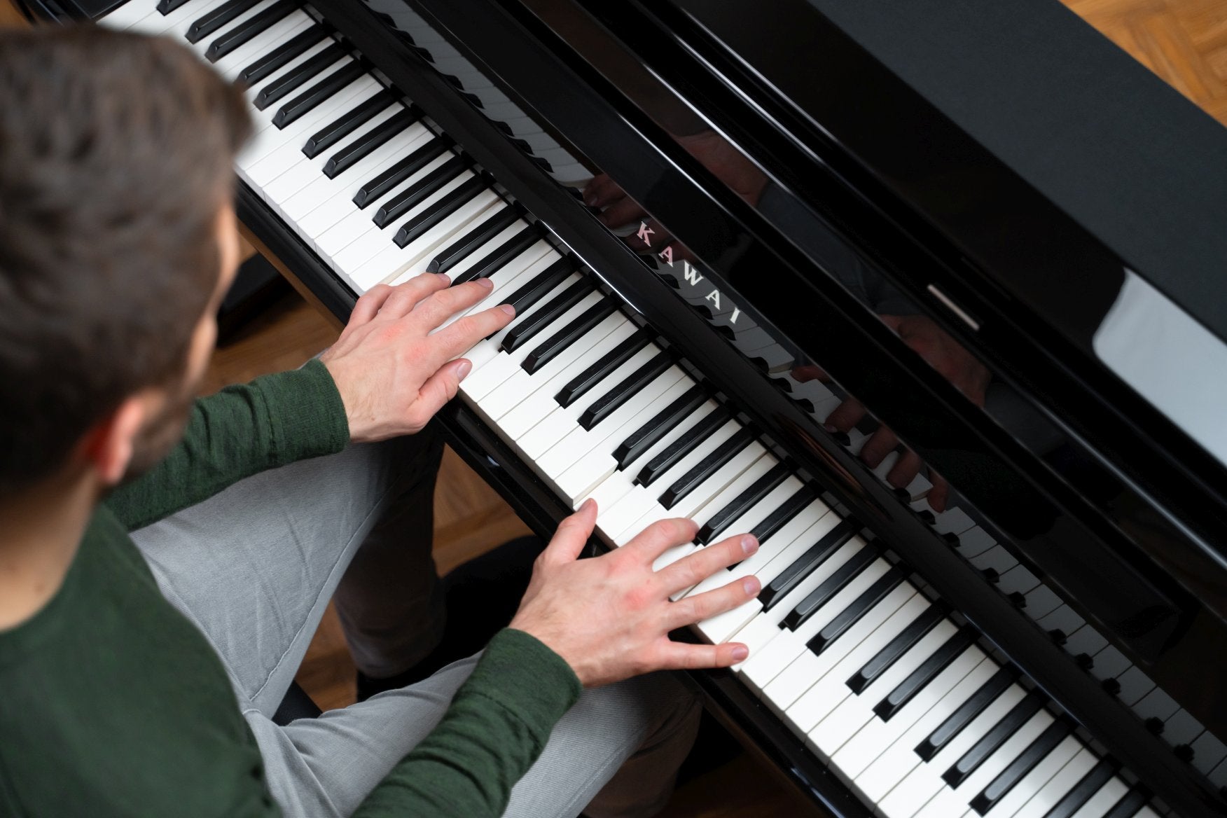 Man playing Kawai digital piano